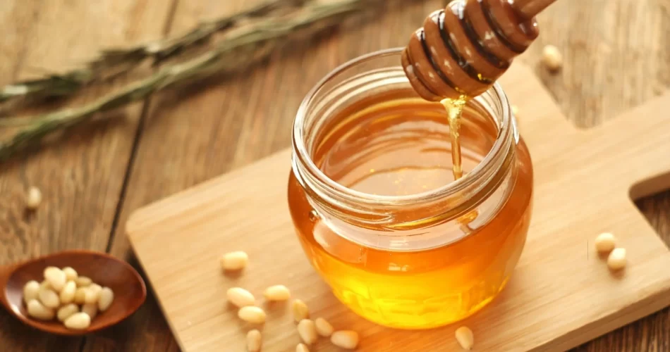 Honey Inside a jar on a wooden table