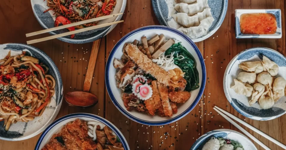 Bowls of tasty Japanese traditional food on a wooden table